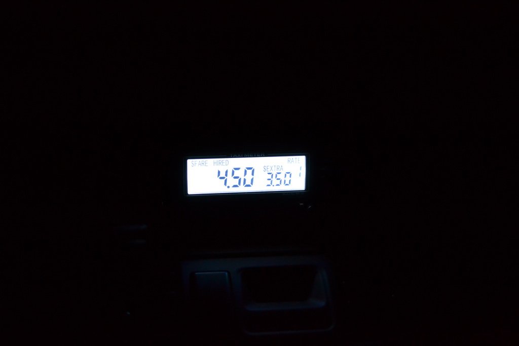 iElectron MT-10 taximeter glowing backlit display at night in a dark car